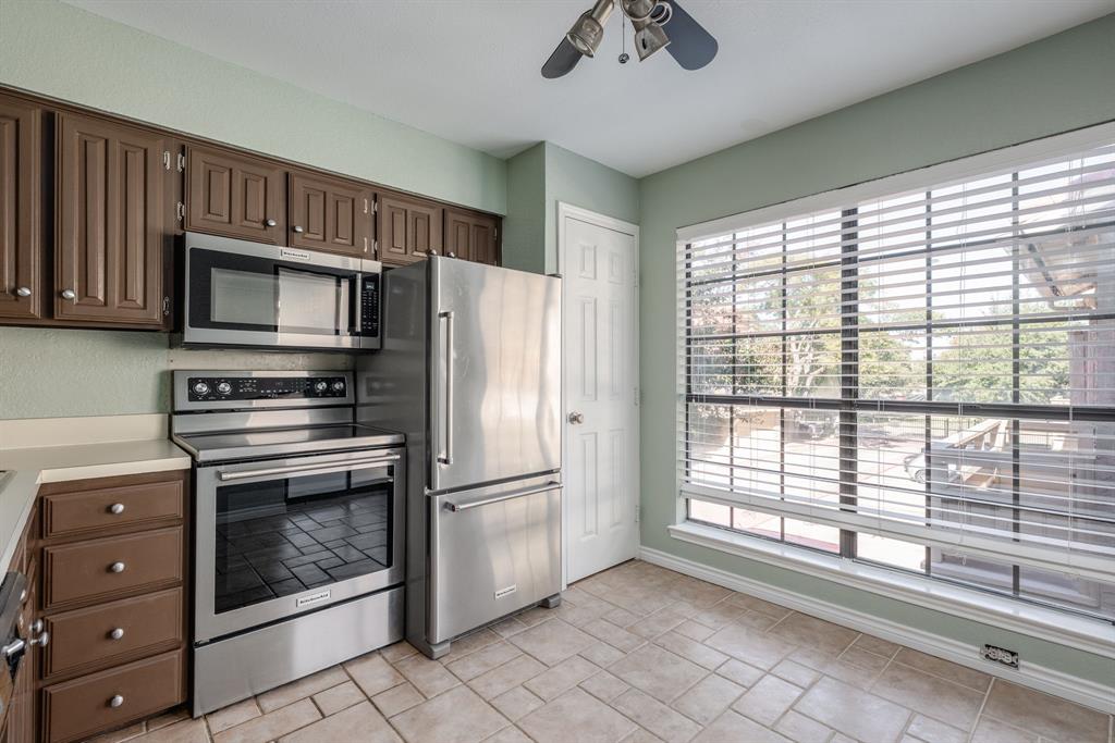 5200 Martel Avenue, Unit 37C Dallas, TX 75206 - Photo 7 of 26 a kitchen with granite countertop a refrigerator and a stove
