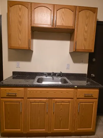 a stove top oven sitting inside of a kitchen