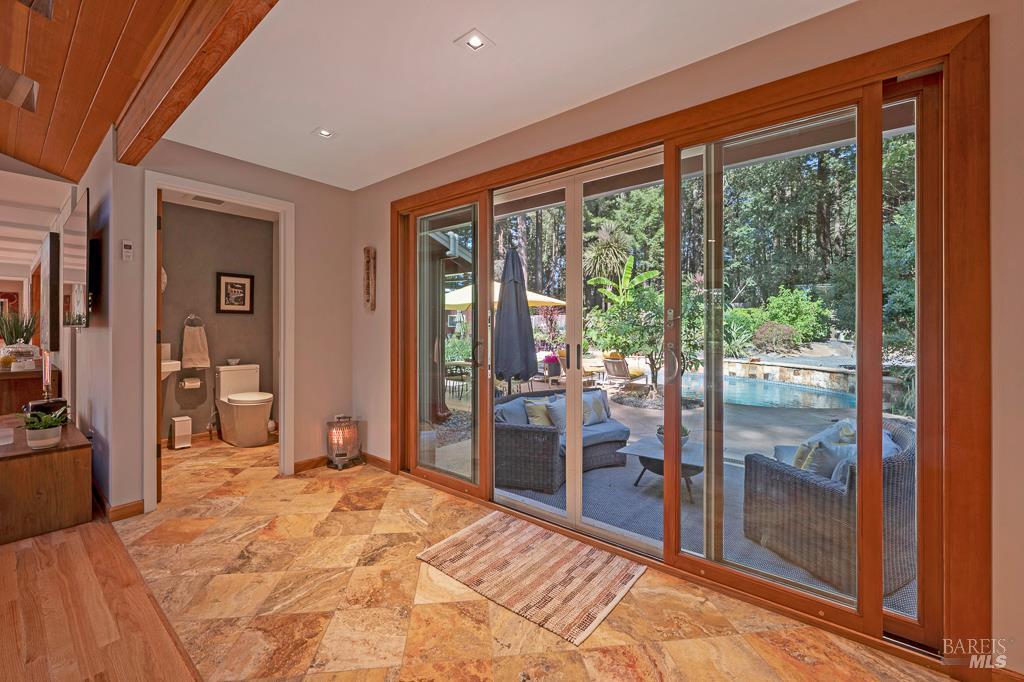 17600 Willow Creek Road Occidental, CA 95465 - Photo 14 of 79 Dripping swimsuit??? No problem, travertine tile from pool area leads to 1/2 bath for swimmers convenience.