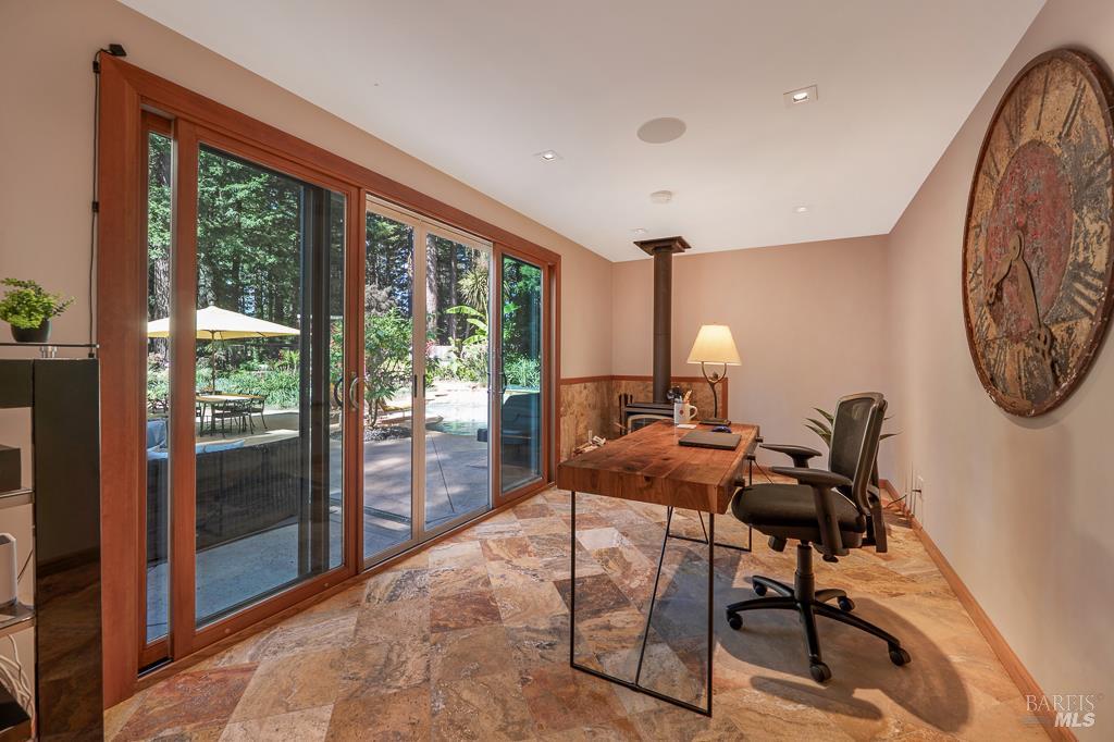 17600 Willow Creek Road Occidental, CA 95465 - Photo 16 of 79 Overlooking the pool and garden, the cozy office/sunroom has a wood burning stove and views of the garden.