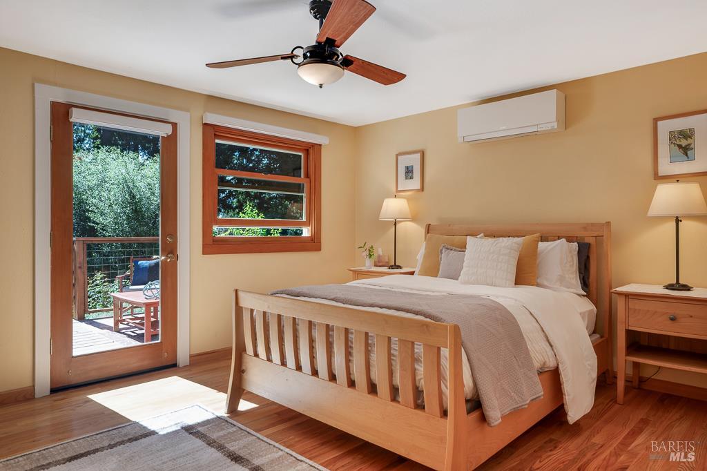17600 Willow Creek Road Occidental, CA 95465 - Photo 21 of 79 One of the two primary bedrooms with ensuite and door to the deck.