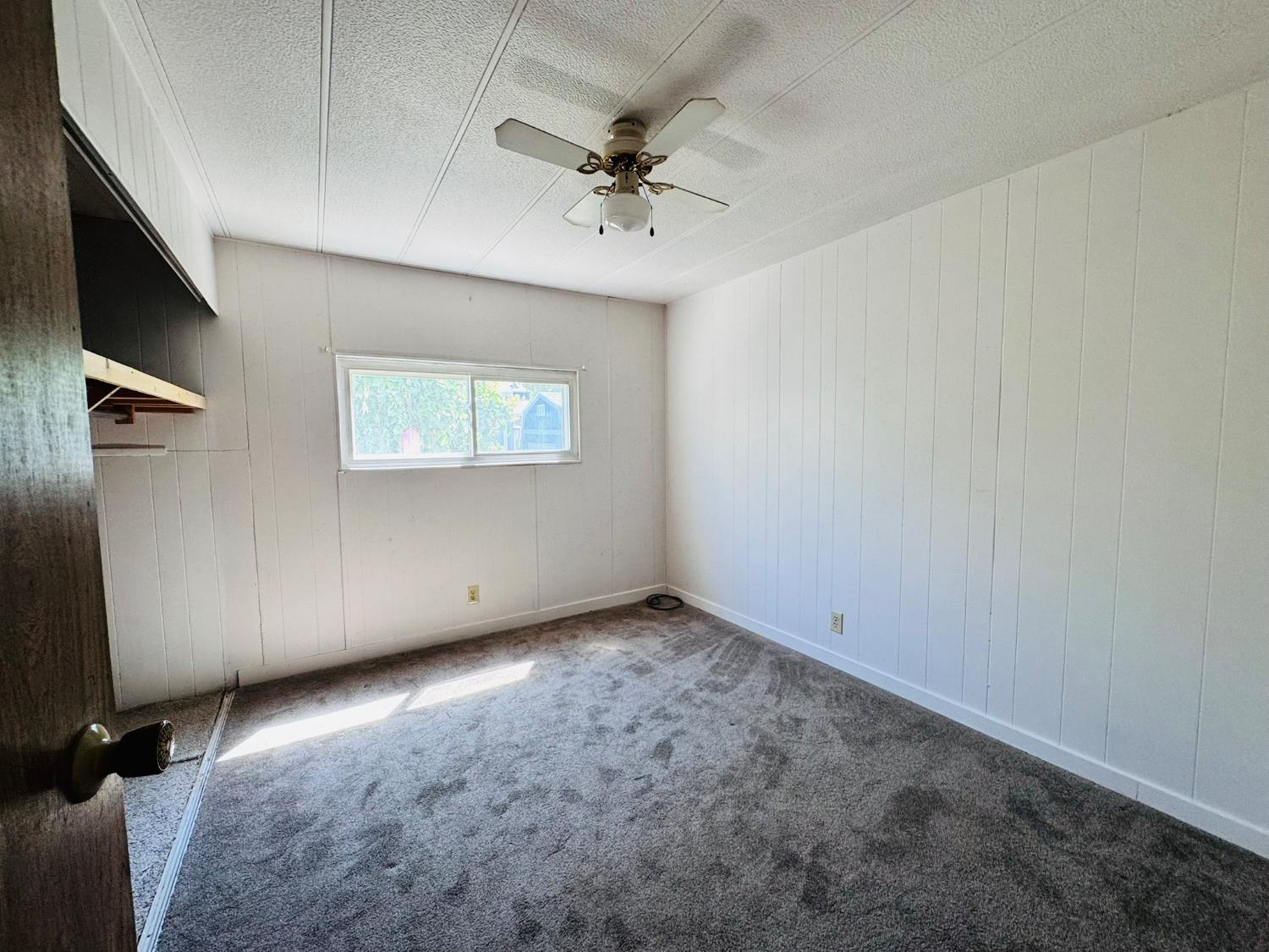 3901 West Lake Road, Unit 123 West Sacramento, CA 95691 - Photo 11 of 26 an empty room with a ceiling fan and a window