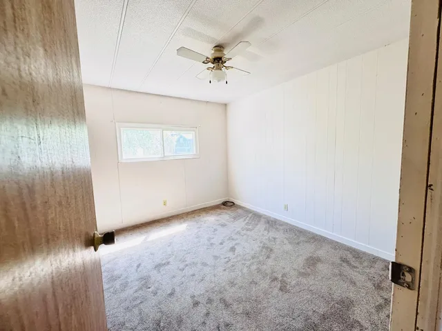a view of an empty room with a ceiling fan