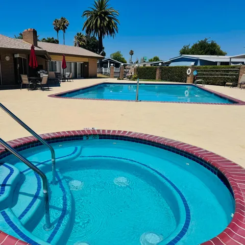 a living room with balcony a couch and bookshelf