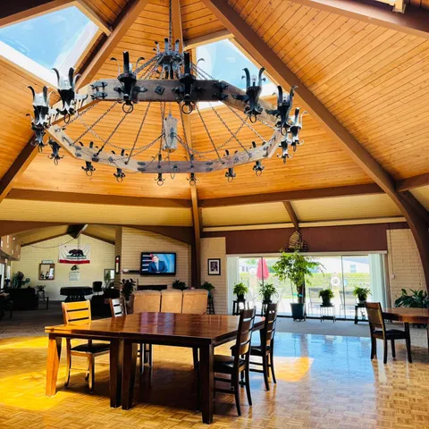 a room with pool table and windows