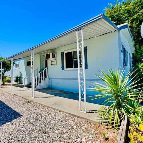 a view of a house with a tree