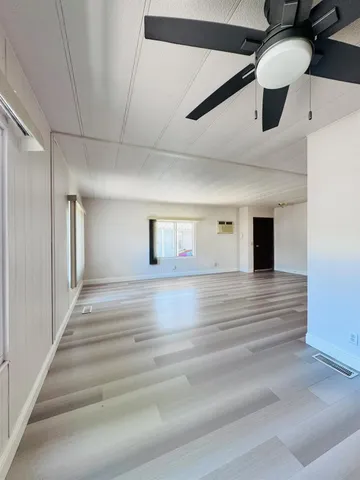 a view of a livingroom with a ceiling fan window and a ceiling fan