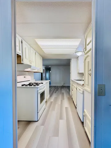 a view of a room with wooden floor and window