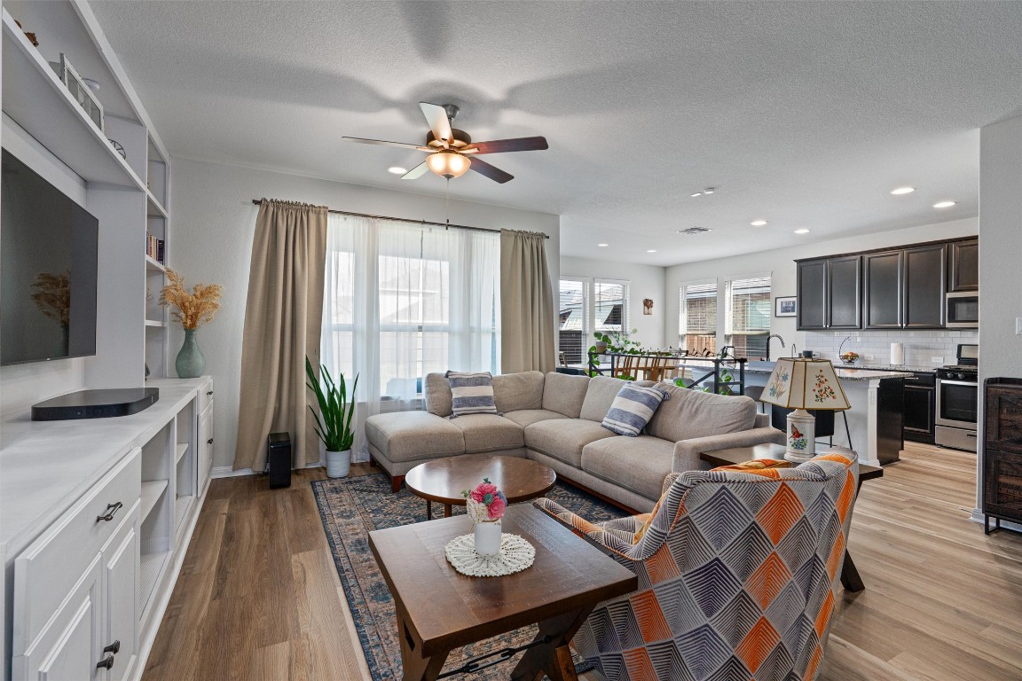 a living room with furniture a dining table and a flat screen tv