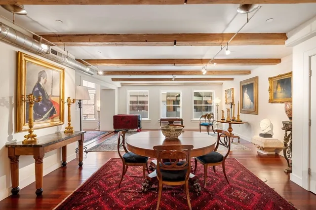a living room with furniture a rug and a window
