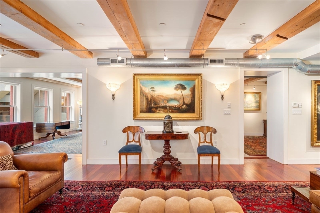1 Winter Place, Unit 3 Boston, MA 02108 - Photo 20 of 38 a living room with furniture and a wooden floor