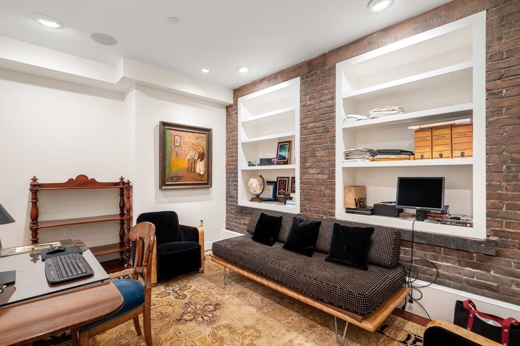 1 Winter Place, Unit 3 Boston, MA 02108 - Photo 23 of 38 a living room with furniture a flat screen tv and a fireplace