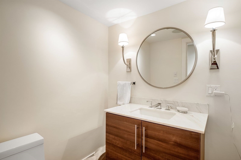 1 Winter Place, Unit 3 Boston, MA 02108 - Photo 32 of 38 a bathroom with a sink vanity and a mirror
