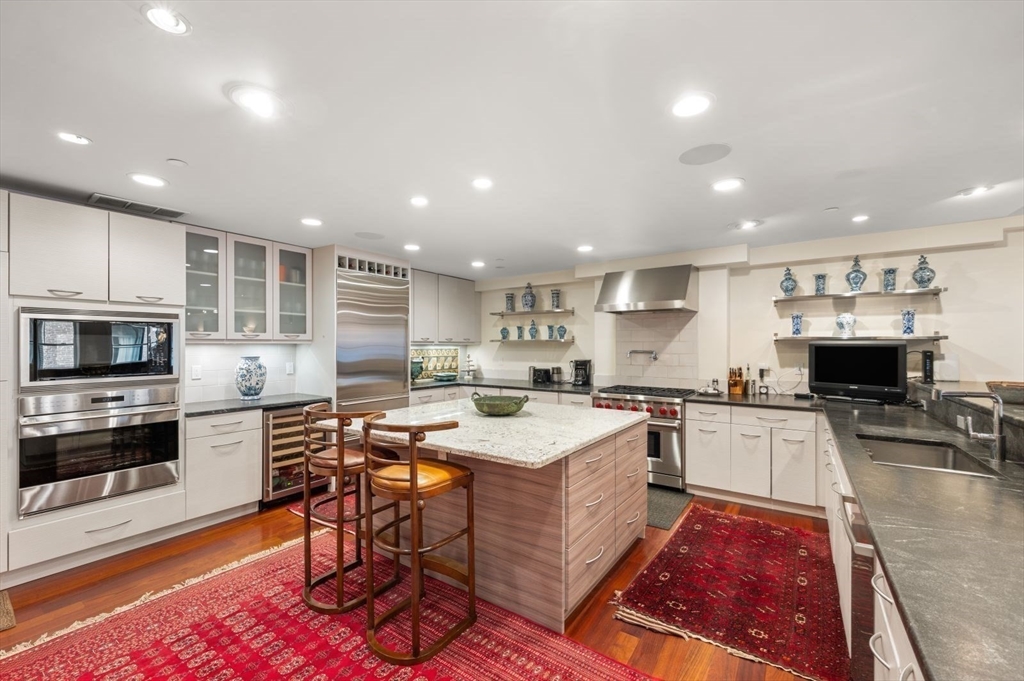 1 Winter Place, Unit 3 Boston, MA 02108 - Photo 10 of 38 a large kitchen with a table and chairs in it