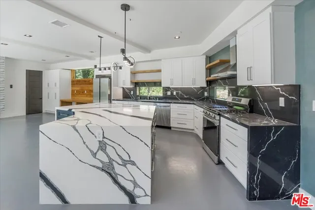 a view of an empty room with a fireplace and a window