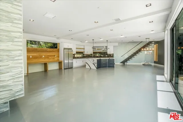 a kitchen with a stove a sink a refrigerator and a dining table