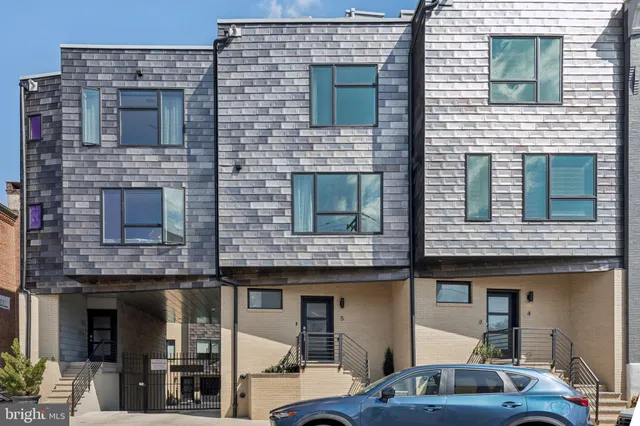 a front view of a building with parking space