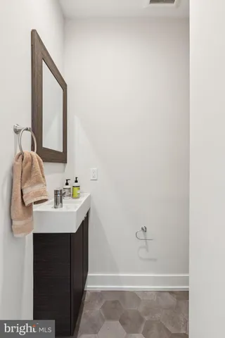 a view of a hallway with wooden floor and stairs