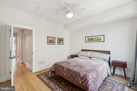 a bedroom with furniture and a wooden floor