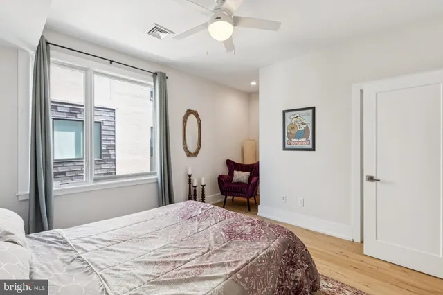 a living room with furniture a flat screen tv and a window