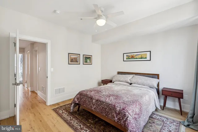a bedroom with furniture and a wooden floor