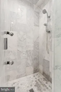 a view of a big room with wooden floor and a ceiling fan