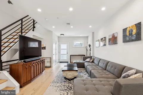 a kitchen with stainless steel appliances kitchen island granite countertop a dining table and chairs