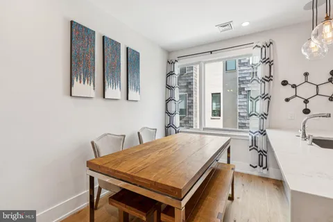 a large kitchen with stainless steel appliances kitchen island granite countertop a large island in the center