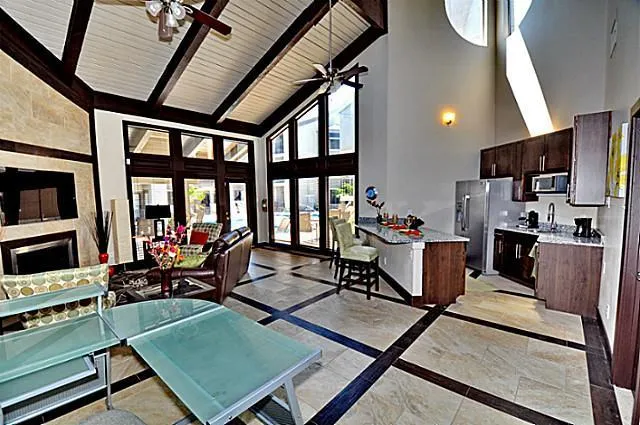 a living room with furniture a flat screen tv and a floor to ceiling window