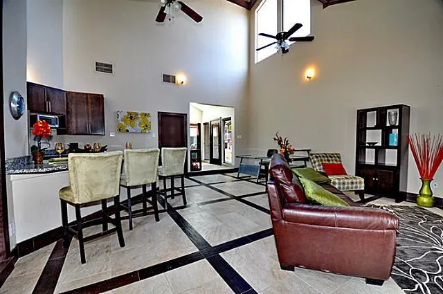 a living room with furniture a air conditioner vent and a wooden floor