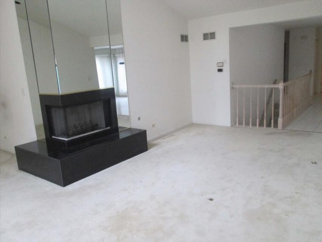1855 Koehling Road Northbrook, IL 60062 - Photo 14 of 17 a living room with a fireplace furniture and a ceiling fan
