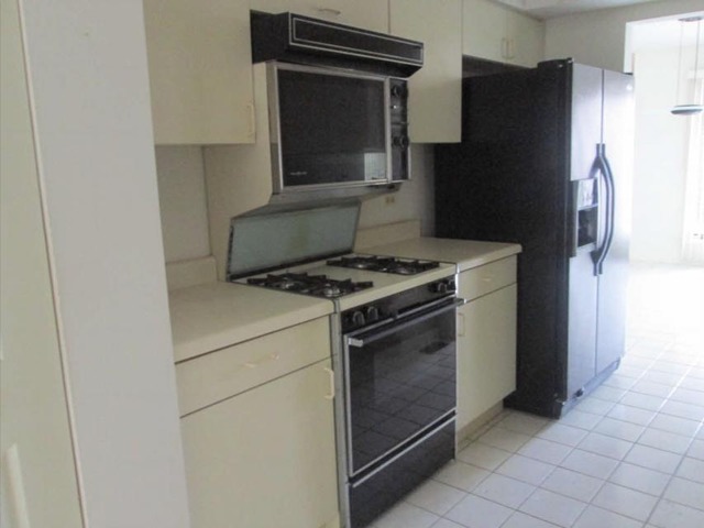 1855 Koehling Road Northbrook, IL 60062 - Photo 15 of 17 a kitchen with a refrigerator stove and cabinets