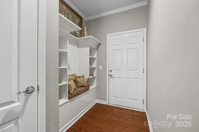 a bedroom with a bed and dresser with mirror