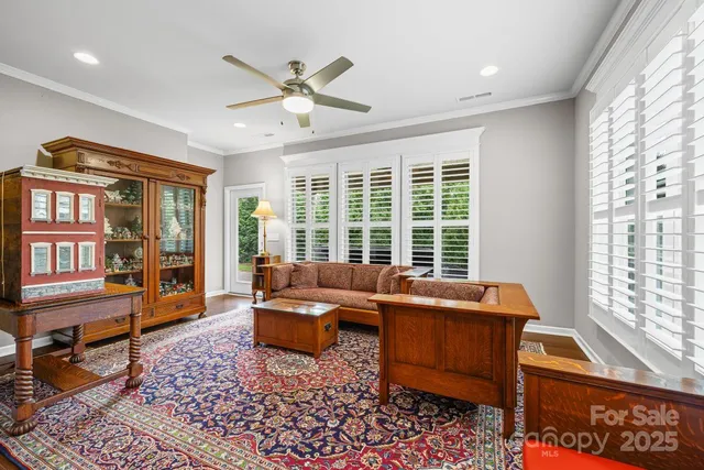 a living room with furniture a rug and a window