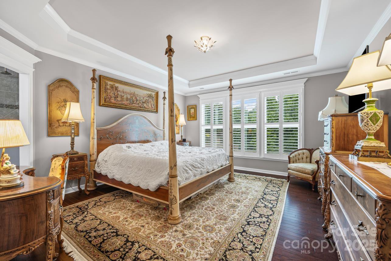 276 Grovefield Drive Fort Mill, SC 29715 - Photo 27 of 44 a bedroom with a bed and wooden floor