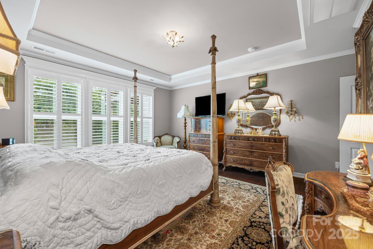 276 Grovefield Drive Fort Mill, SC 29715 - Photo 28 of 44 a bedroom with a bed and wooden floor