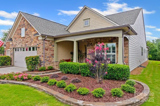 a front view of a house with garden