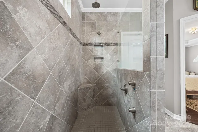 a view of walk in closet with clothes