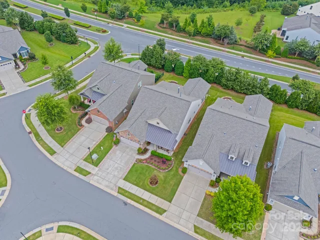 an aerial view of a house with a garden and a swimming pool