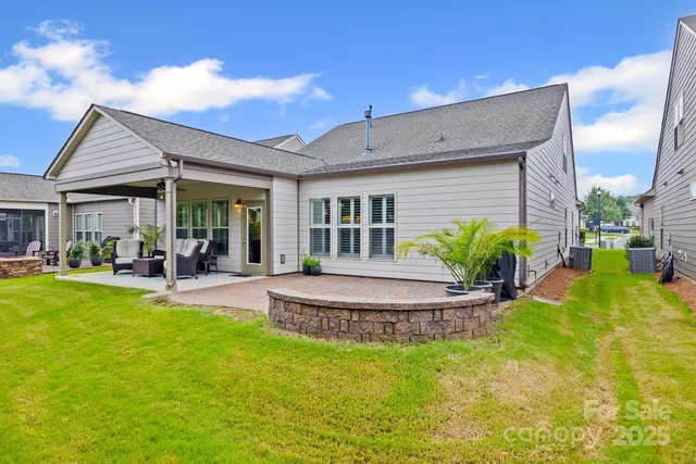 a view of a house with a yard patio and swimming pool
