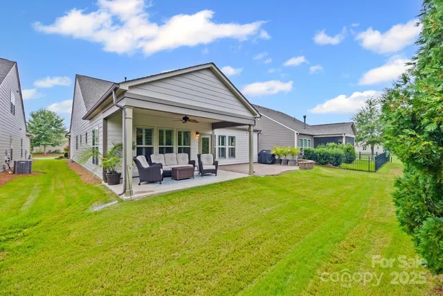a view of house with backyard and patio