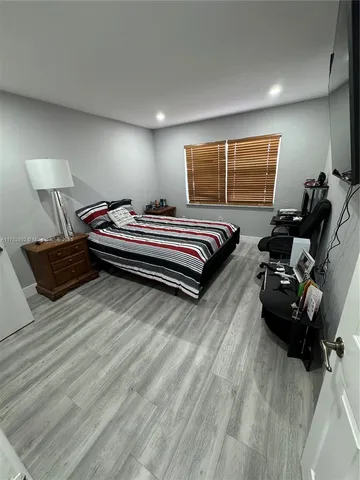 a bedroom with furniture and a window