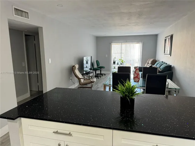 a living room with furniture potted plant and a window