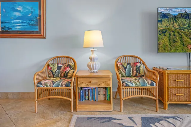 a living room with furniture a rug and a chandelier