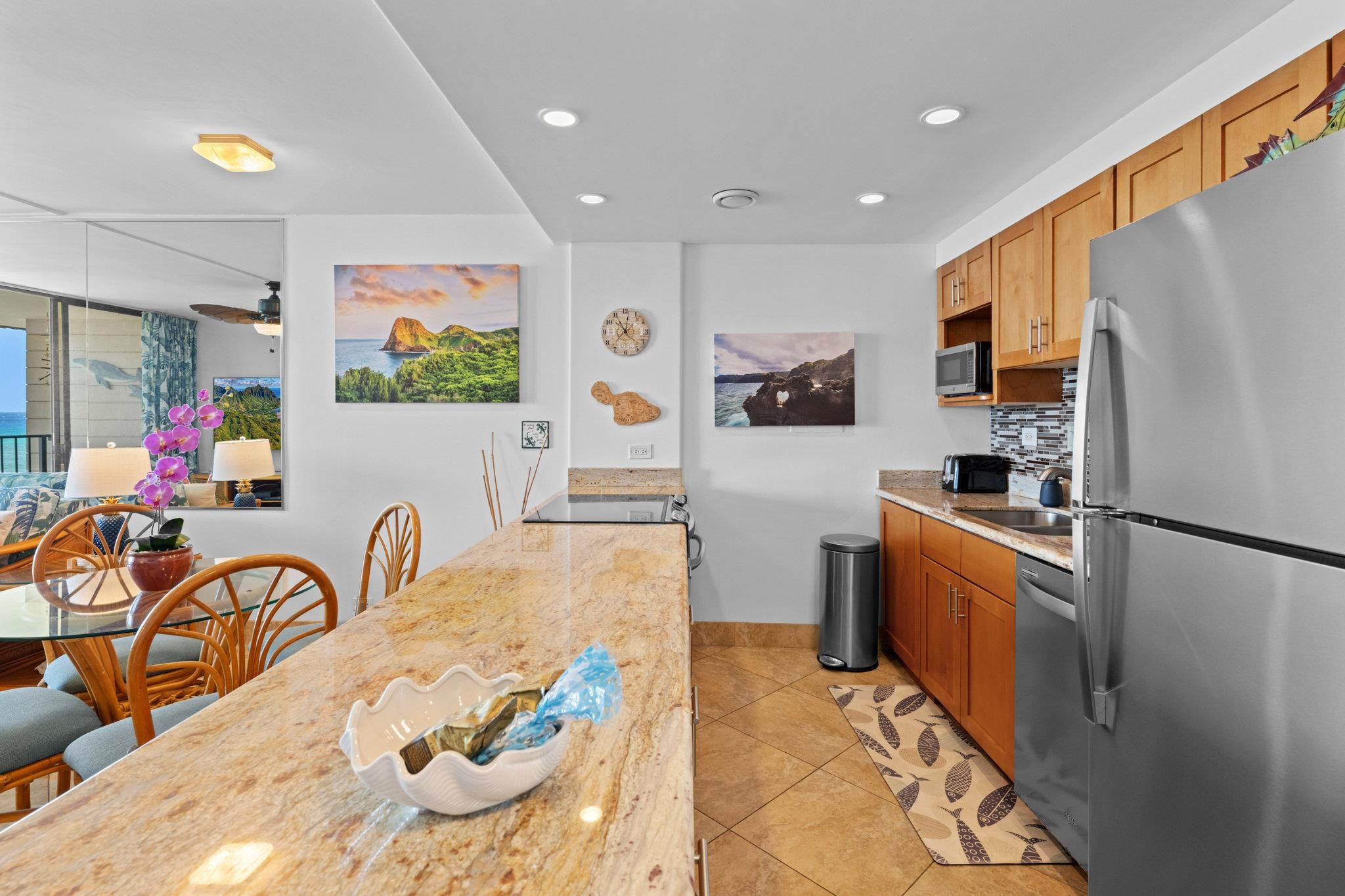 4471 Lower Honoapiilani Road, Unit 415 Lahaina, HI 96761 - Photo 23 of 44 a kitchen with stainless steel appliances granite countertop a refrigerator and a sink