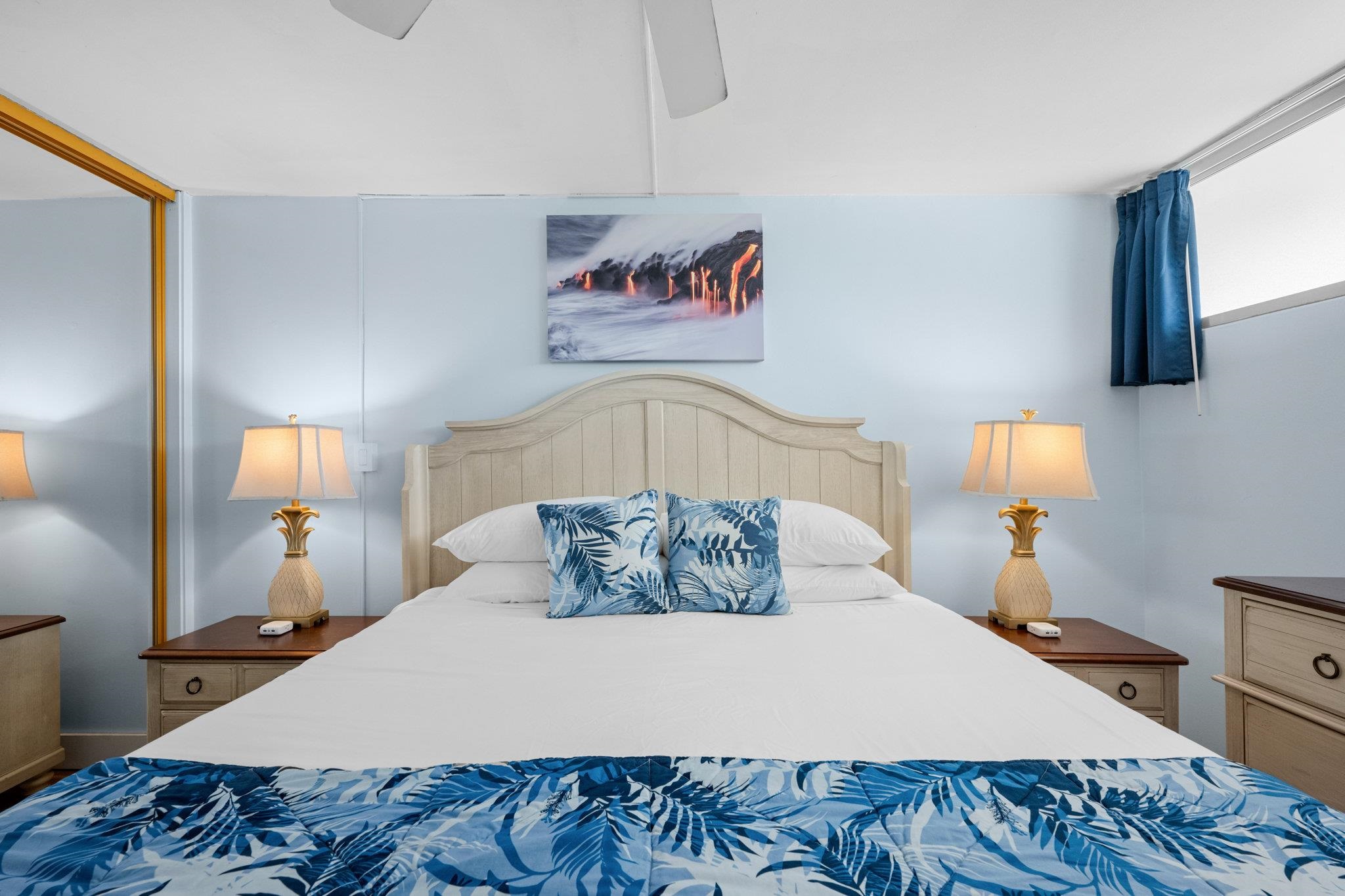 4471 Lower Honoapiilani Road, Unit 415 Lahaina, HI 96761 - Photo 27 of 44 a bedroom with a bed and a lamp on dresser