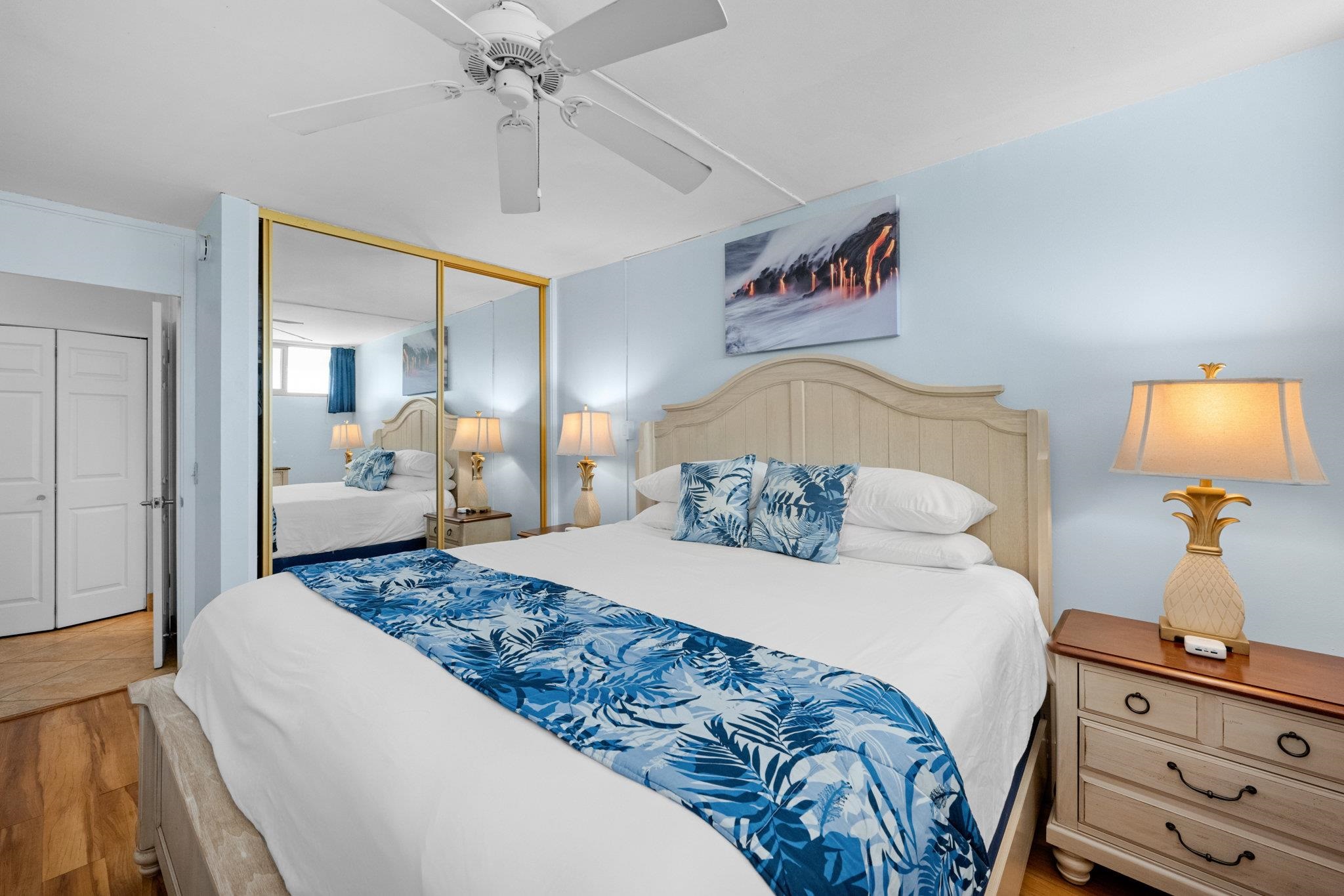 4471 Lower Honoapiilani Road, Unit 415 Lahaina, HI 96761 - Photo 29 of 44 a bedroom with a bed and a mirror on dresser