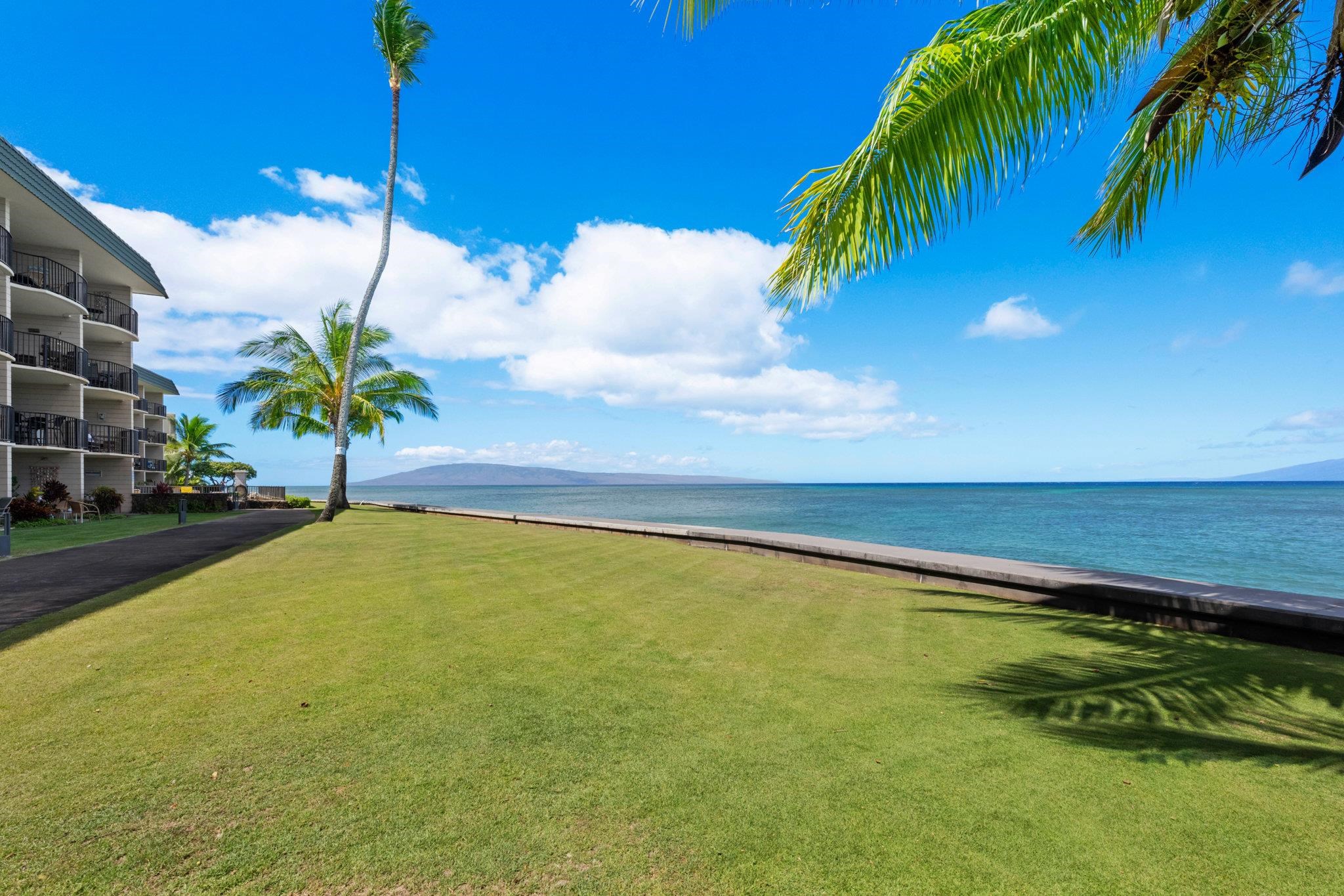 4471 Lower Honoapiilani Road, Unit 415 Lahaina, HI 96761 - Photo 40 of 44 a view of a swimming pool with a table and chairs