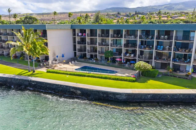 a view of swimming pool with outdoor seating and yard in the back