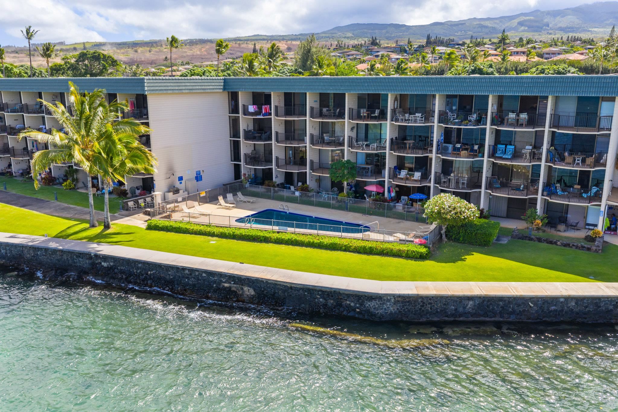 4471 Lower Honoapiilani Road, Unit 415 Lahaina, HI 96761 - Photo 4 of 44 a view of swimming pool with outdoor seating and yard in the back